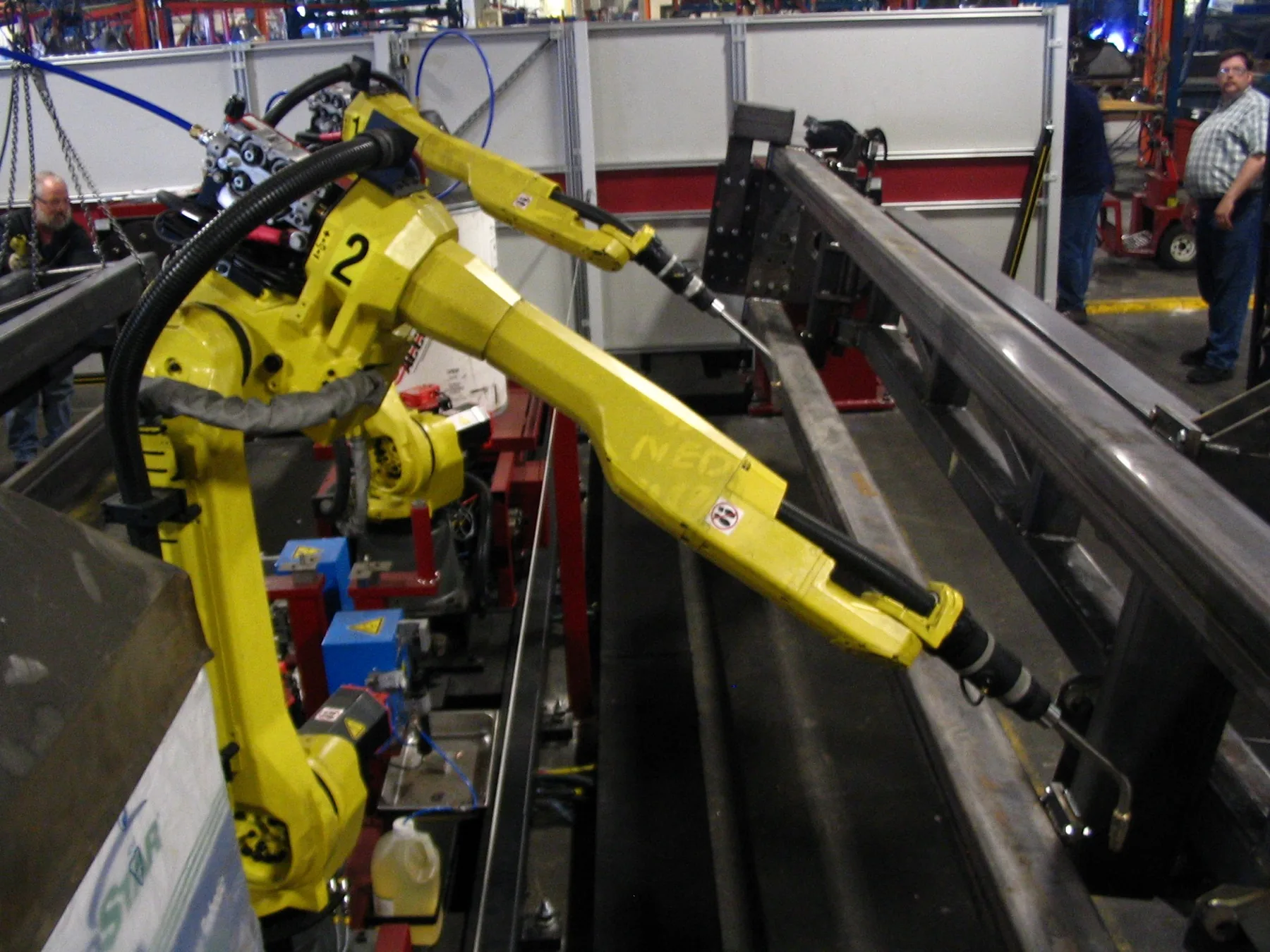 Robotics automation cell photographed in an industrial production environment